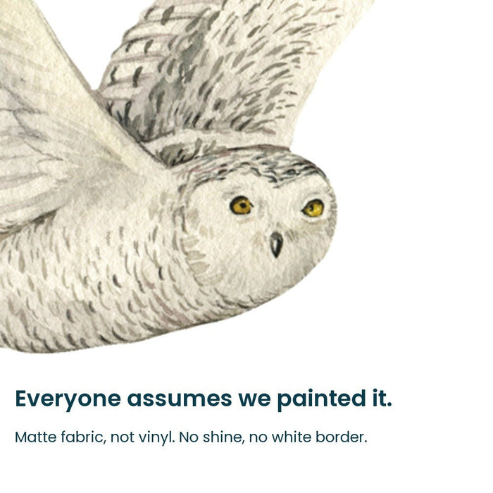 Close-up of the hand-painted snowy owl face on matte fabric