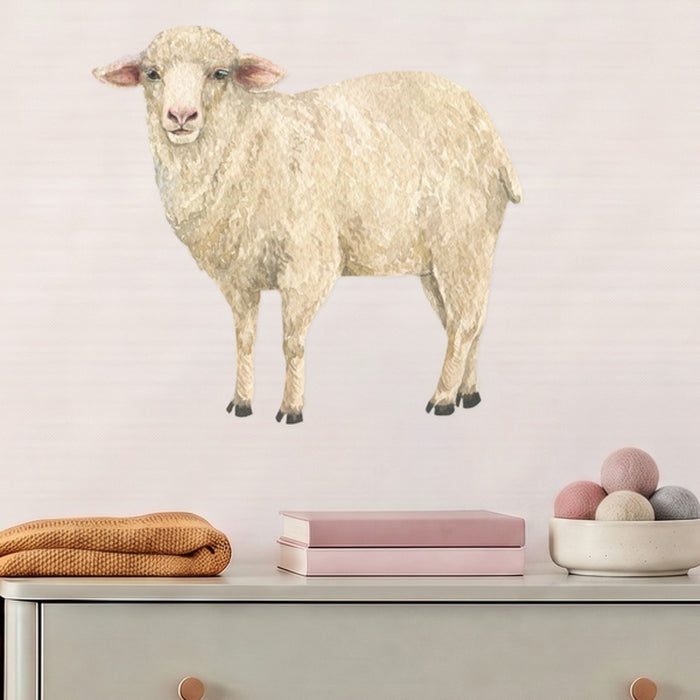 Large sheep wall decal above a sage dresser in a nursery