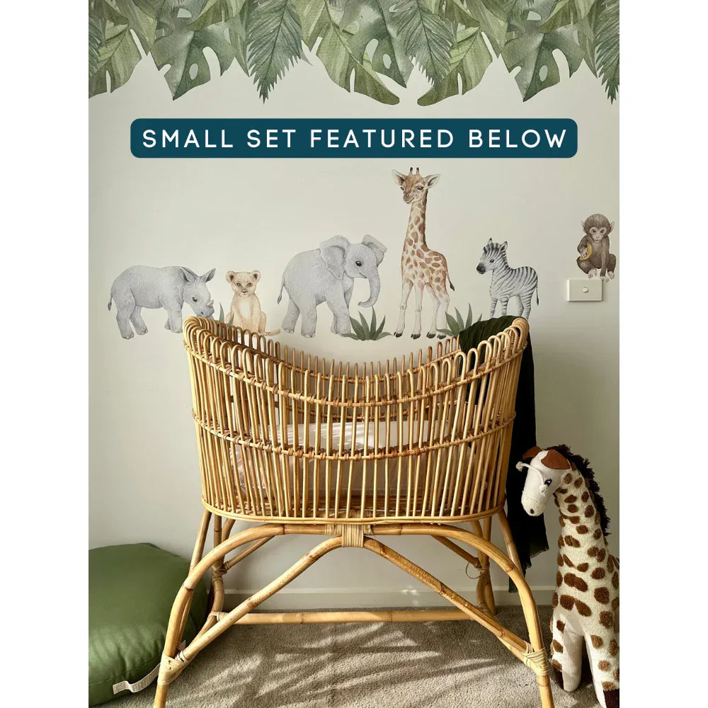 Baby Safari Small Set decals in a nursery beside a cane bassinet