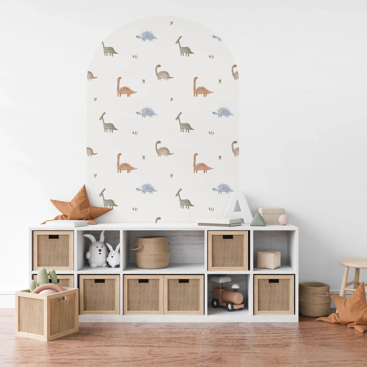 Archer dinosaur arch decal above white storage cubes in a playroom