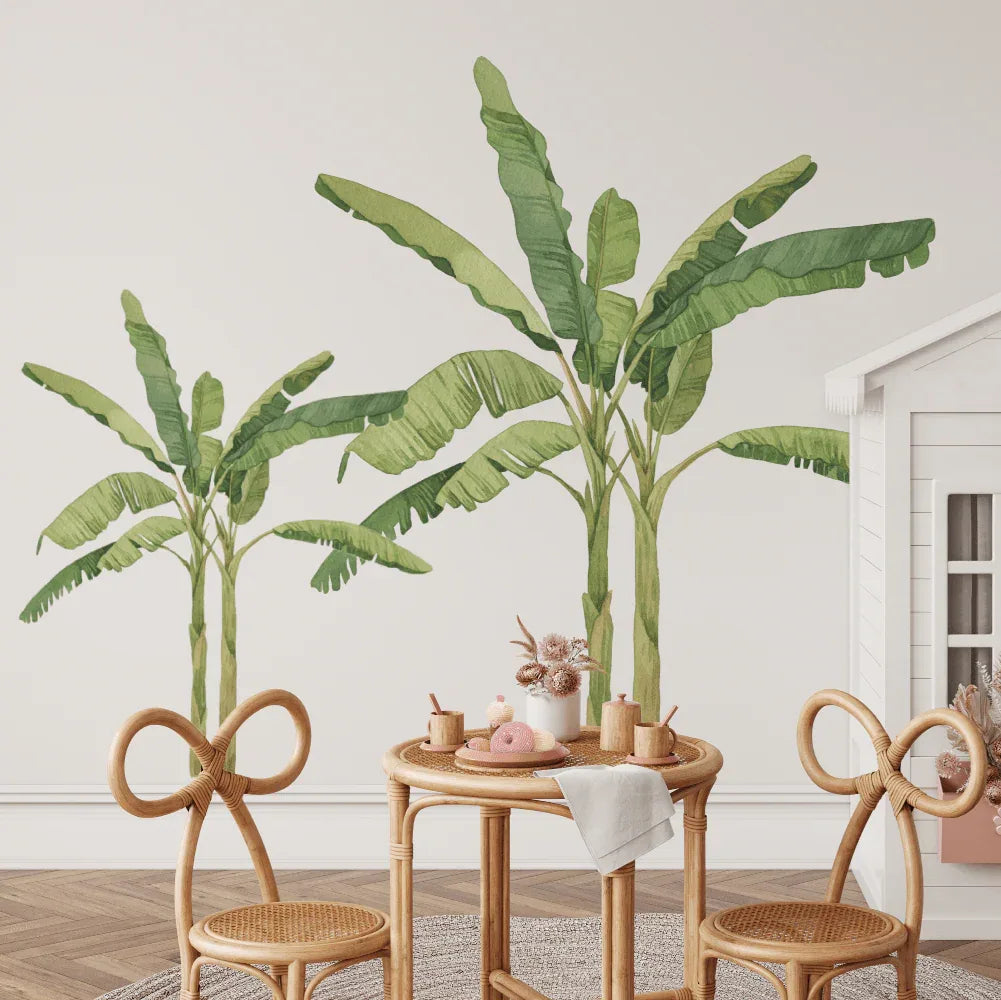 Two banana palm tree decals in a playroom with a kids table
