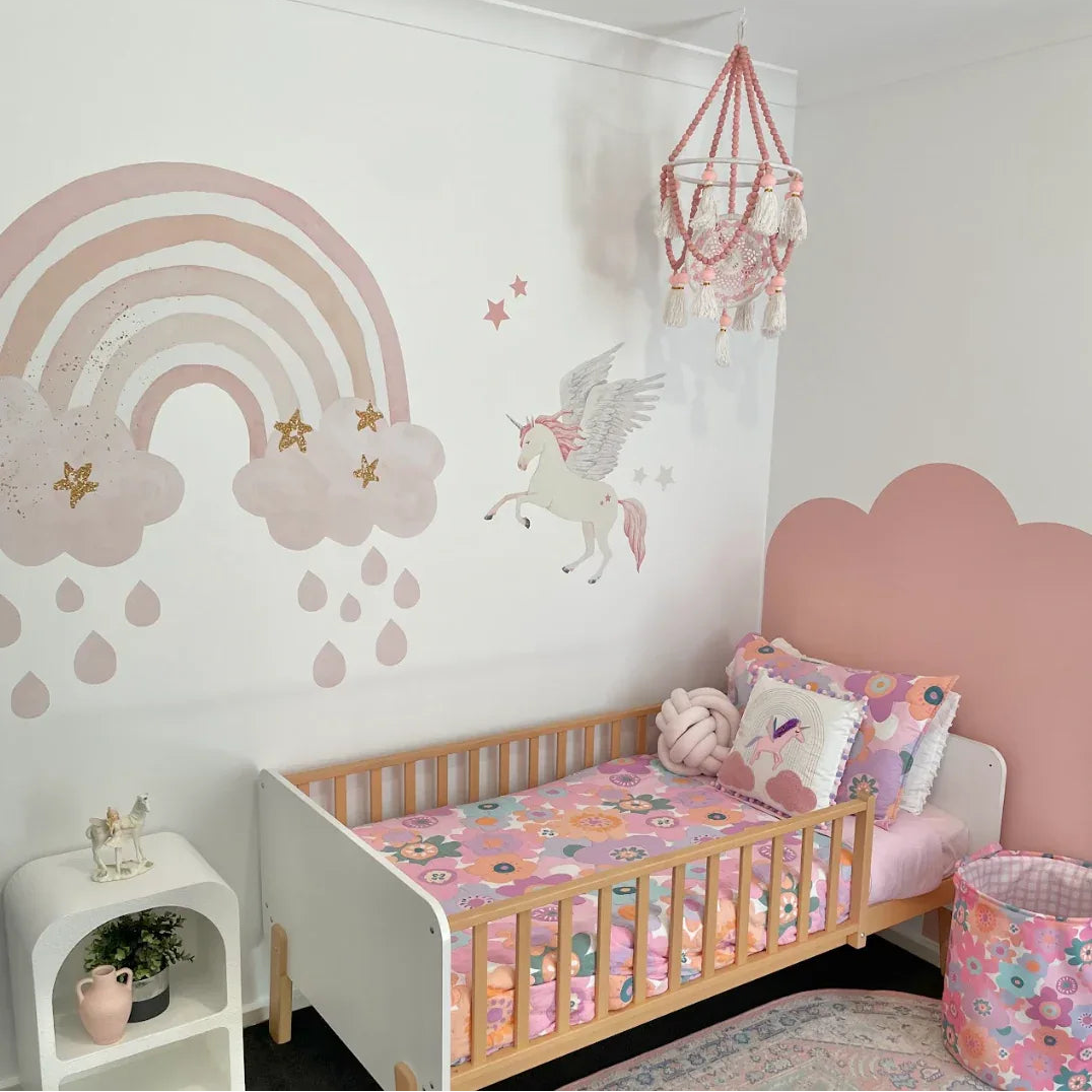 Children's bedroom with a crib, colorful bedding, and wall decorations.