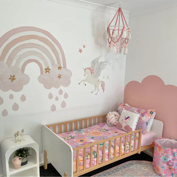 Children's bedroom with a crib, colorful bedding, and wall decorations.