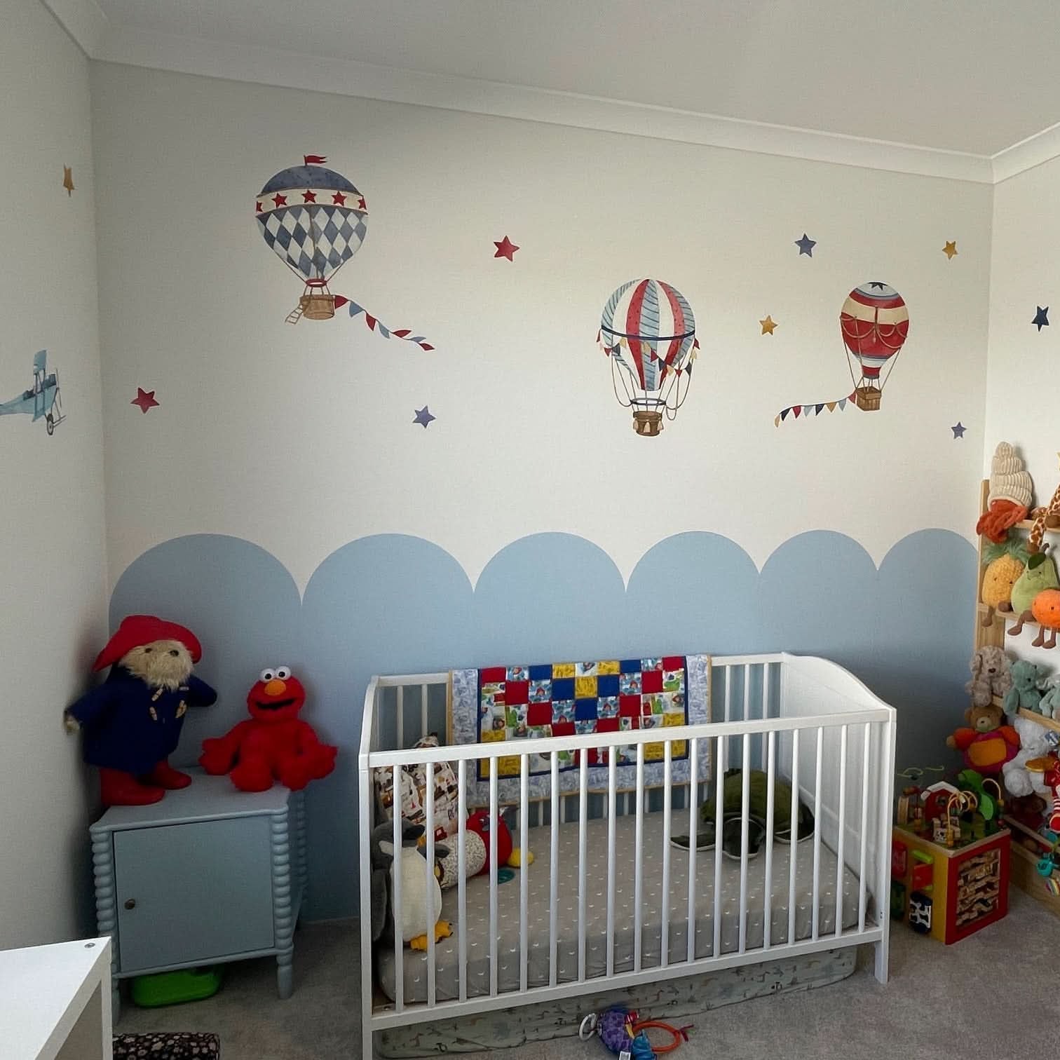 Children's room with crib, toys, and wall decorations