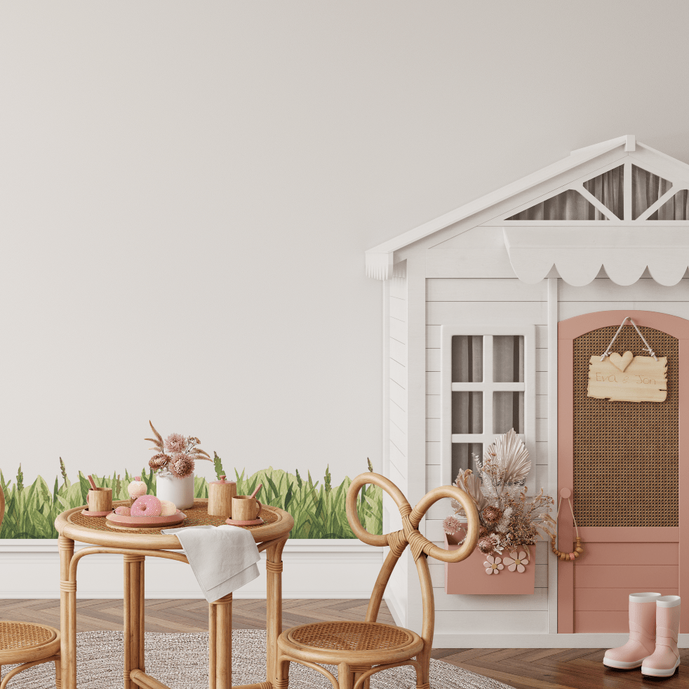 Green grass wall trim decal beneath a cubby house in a playroom