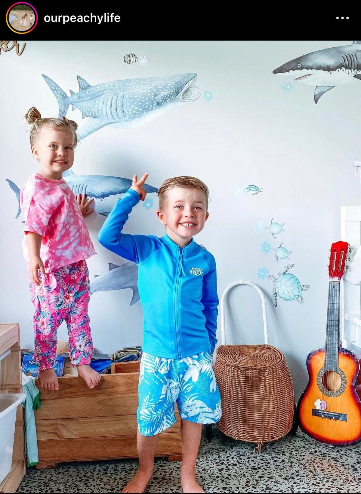 Customer photo of two children in front of shark wall decals