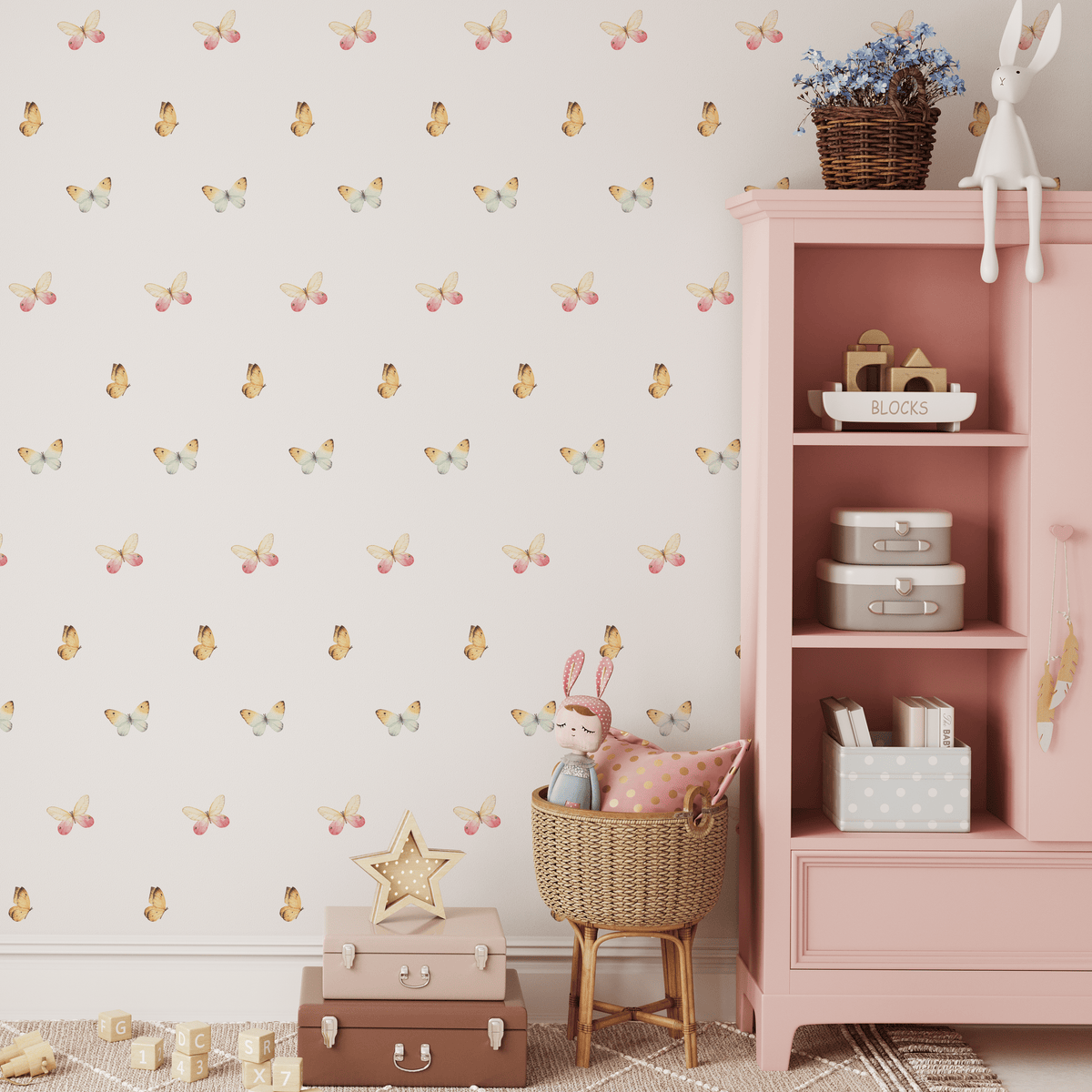 Mixed butterfly decals in yellow and pink beside a pink bookshelf