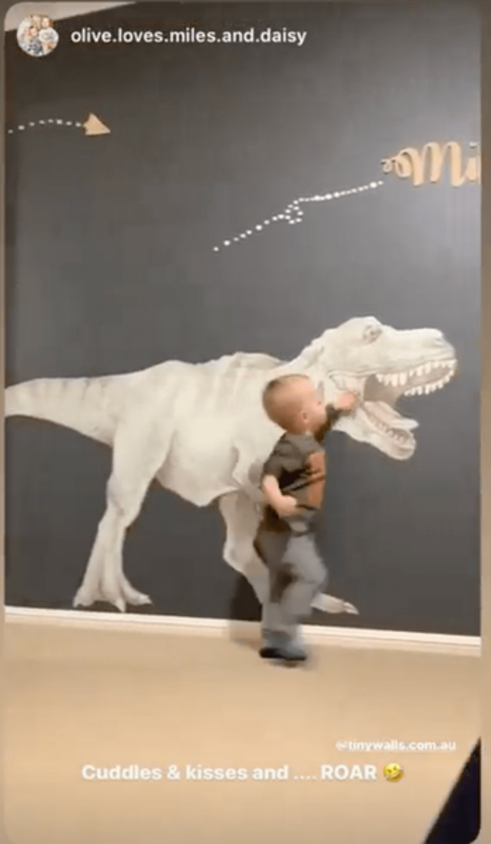 Customer photo of a child in front of a T-Rex wall decal