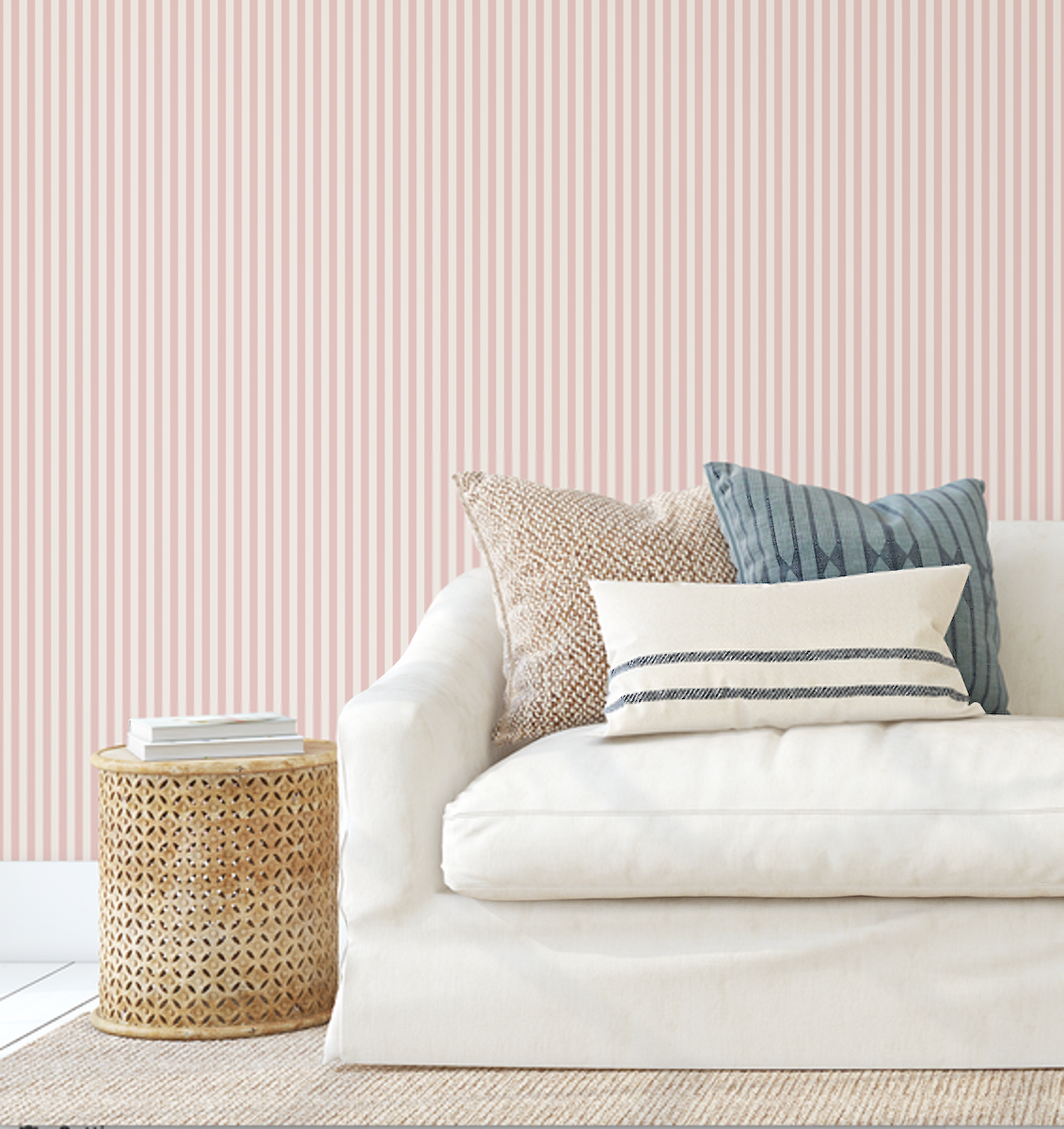 Mini Stripes Pink wallpaper behind a cream sofa with striped cushions