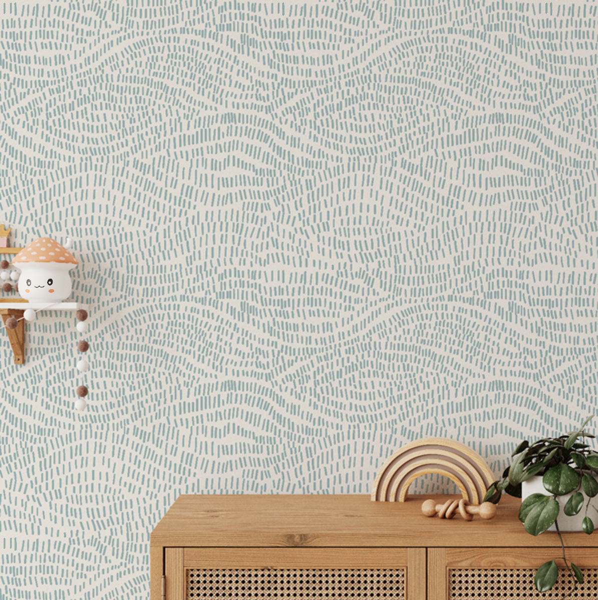 Zane Seafoam Lines wallpaper above a cane sideboard with wooden toys