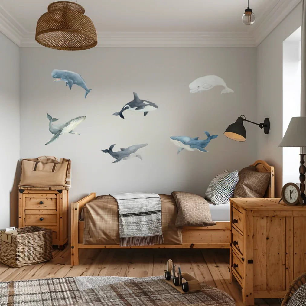 Whale wall decals above a timber bed in a boys bedroom
