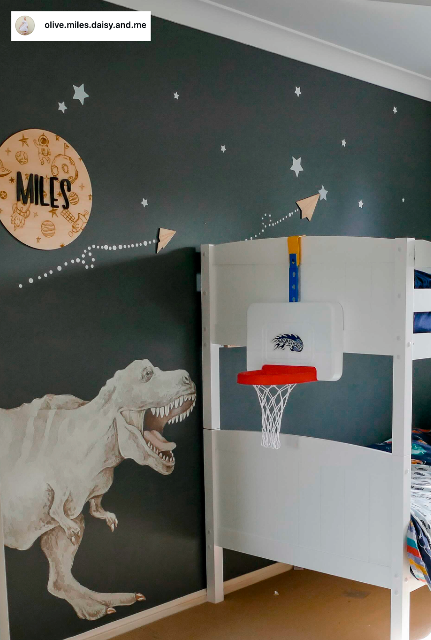 Customer photo of a T-Rex decal on a dark green bedroom wall