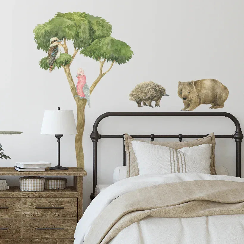 Australian gum tree decals with koalas, wombat and echidna above a bed