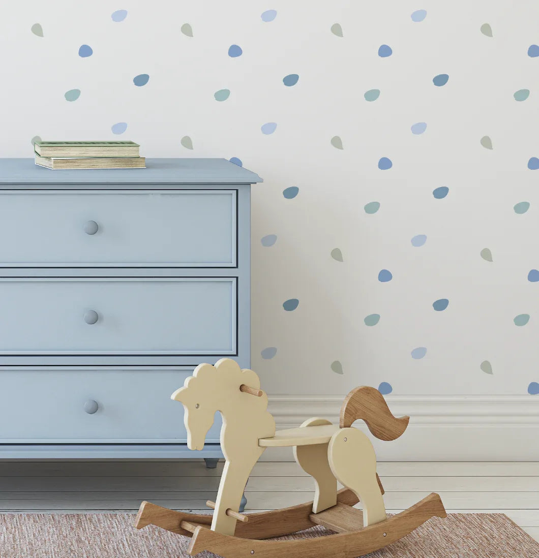Happy Dots Cool and Calm decals above a blue dresser with a wooden rocking horse