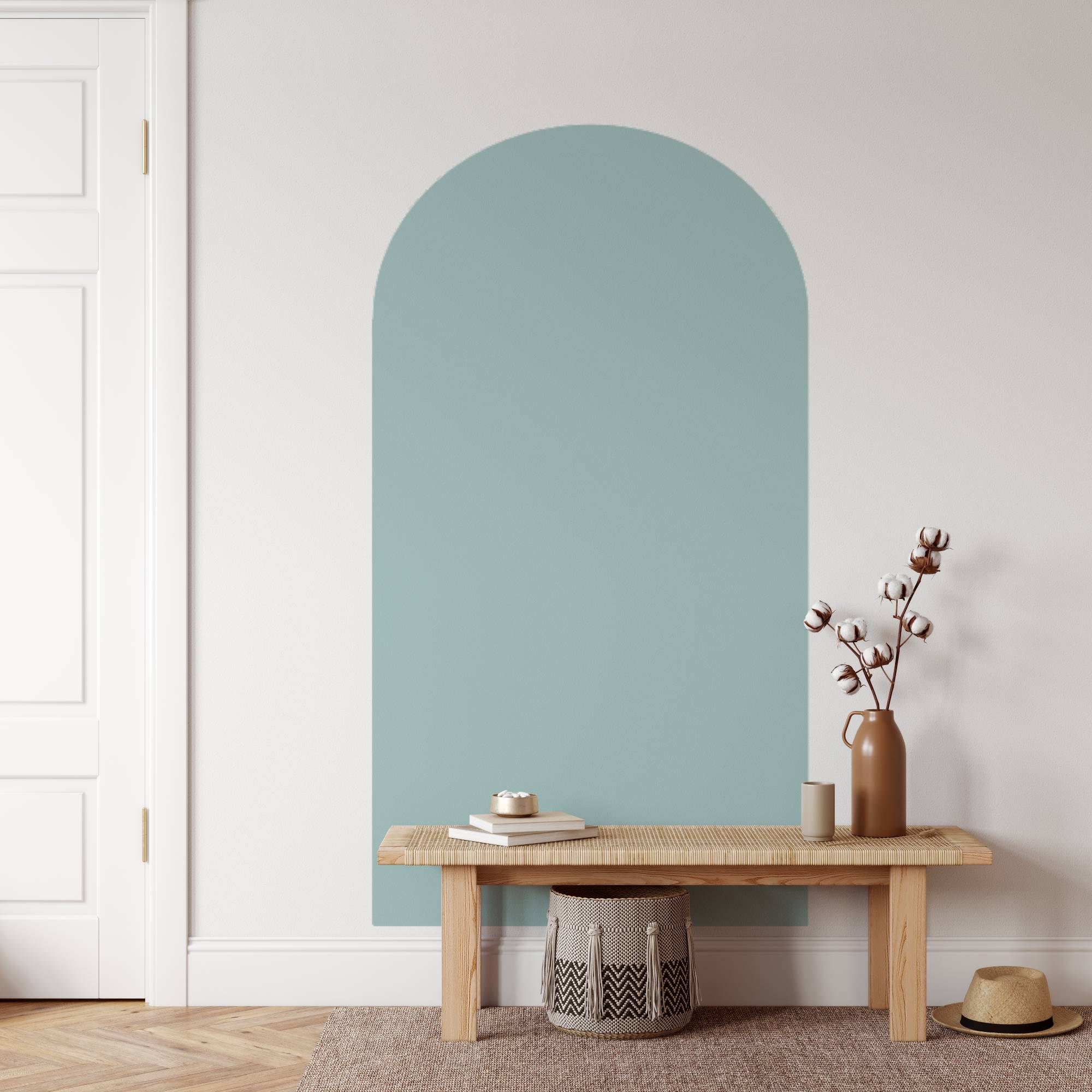 Arched light blue wall panel in a room with a wooden bench and decorative items.