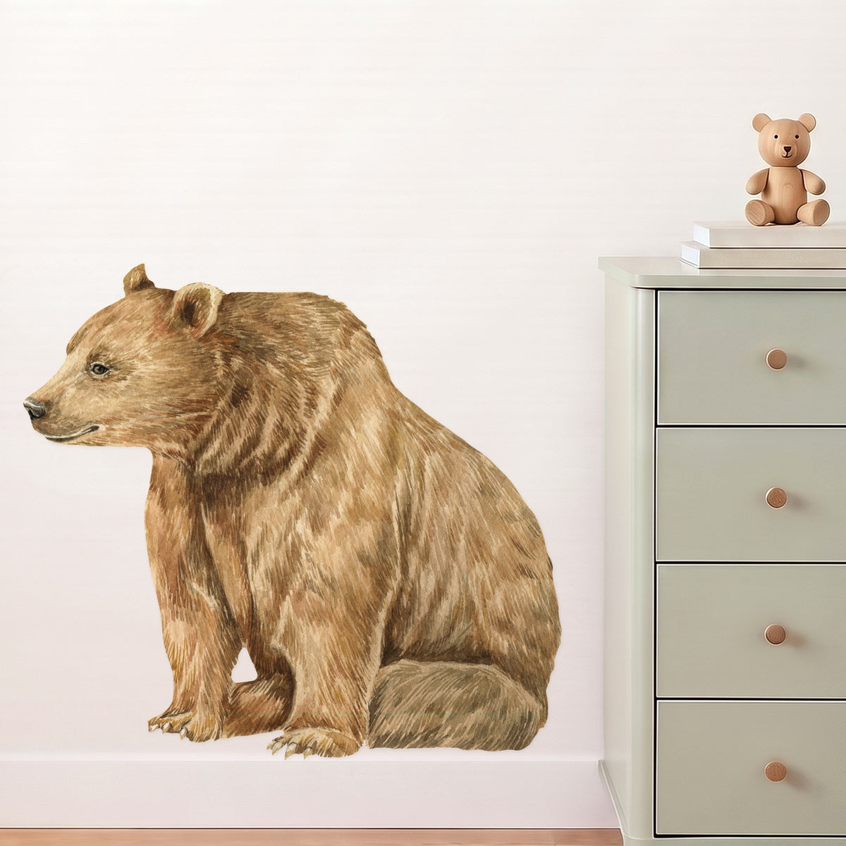 Large bear wall decal sitting beside a sage dresser in a nursery
