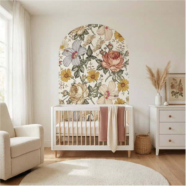 Nursery room with floral wall mural, crib, and armchair.