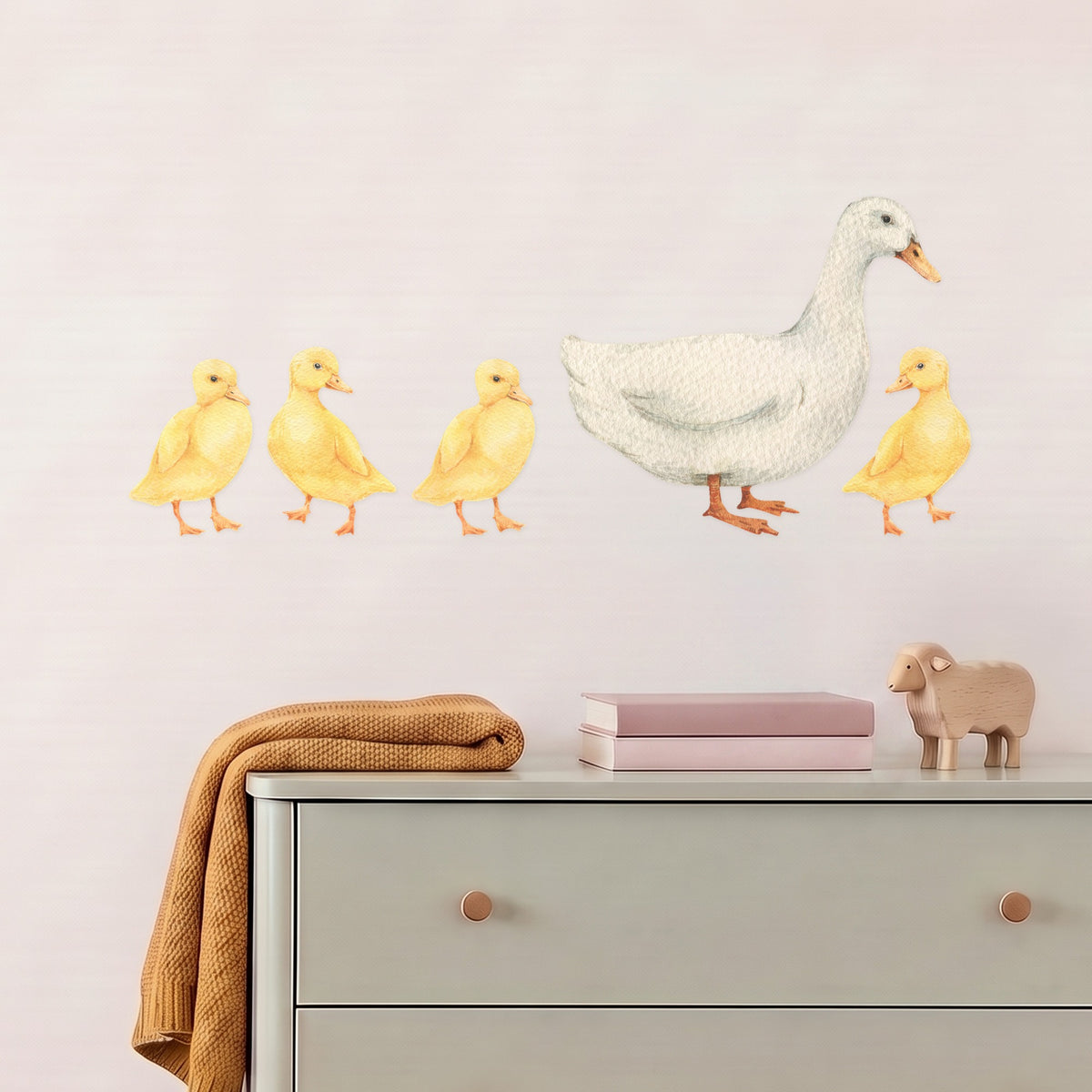 Large duck and four ducklings wall decals above a sage chest of drawers in a nursery