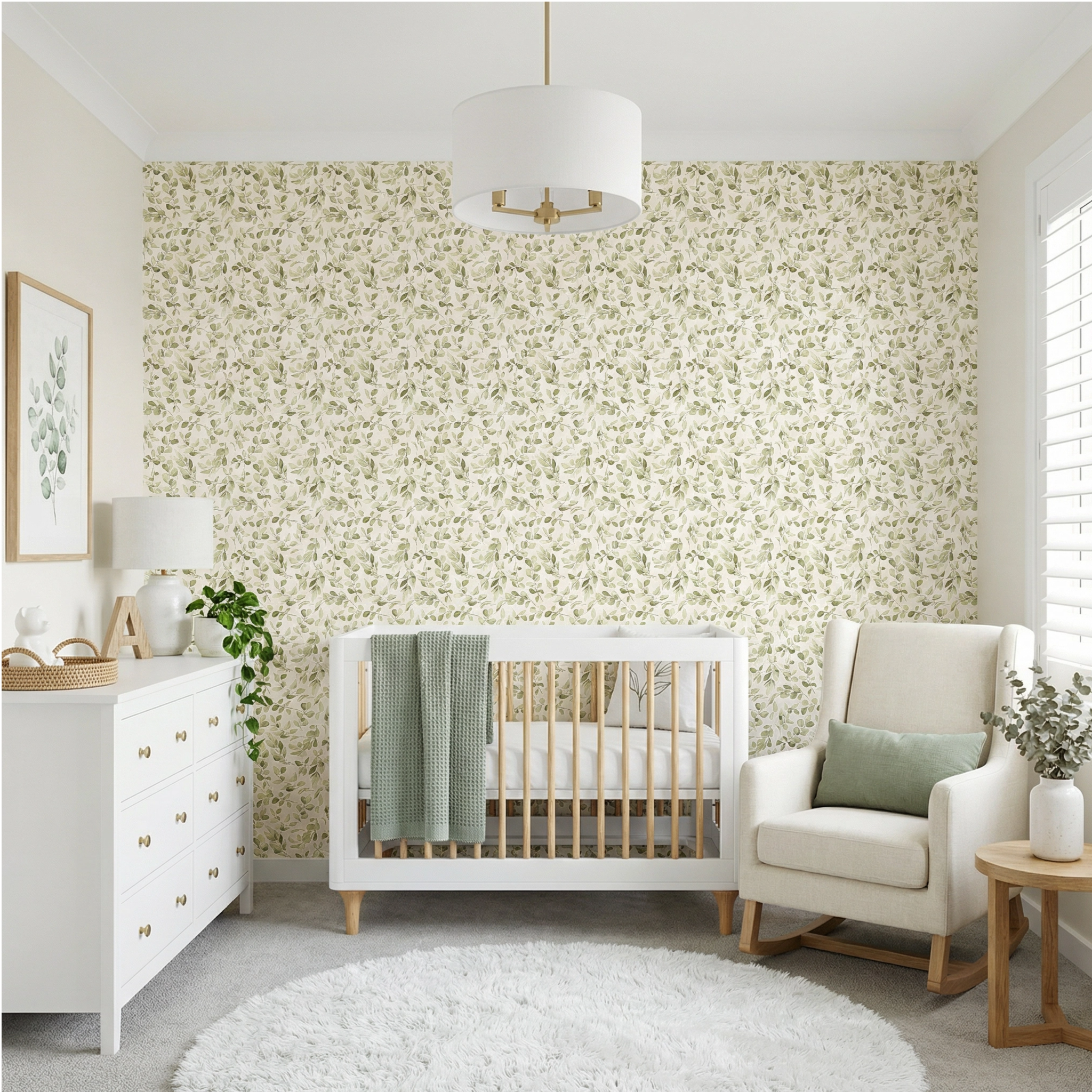 Nursery room with white crib, armchair, and dresser against a floral wallpaper wall.