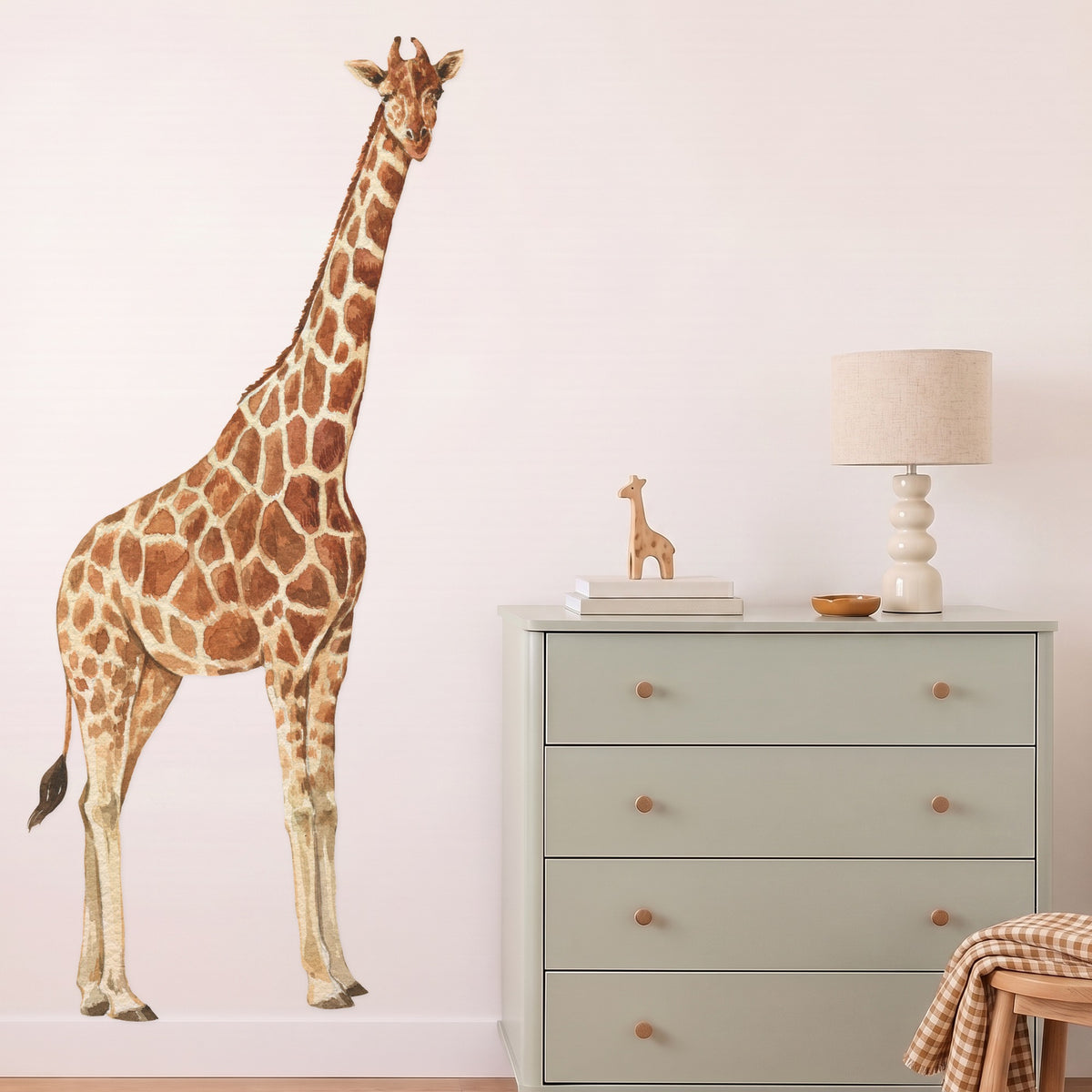 Giraffe wall decal standing on the skirting in a styled nursery