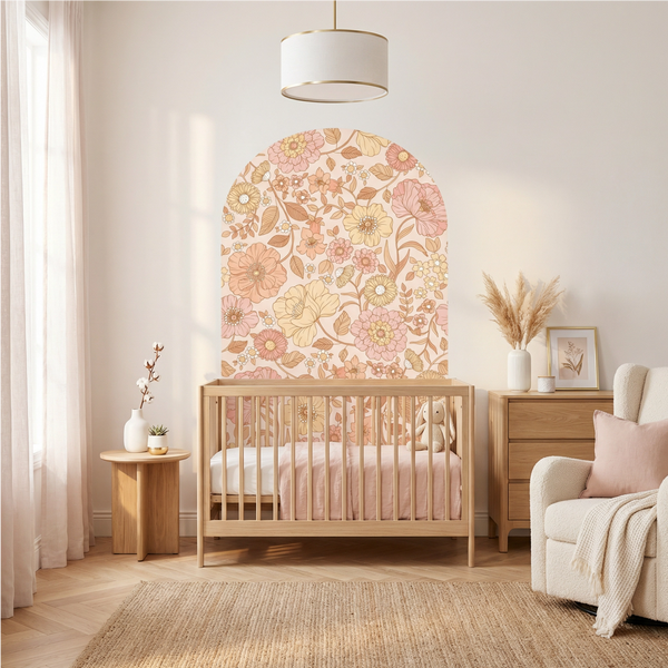 Nursery room with wooden crib, floral wall art, and decorative elements.