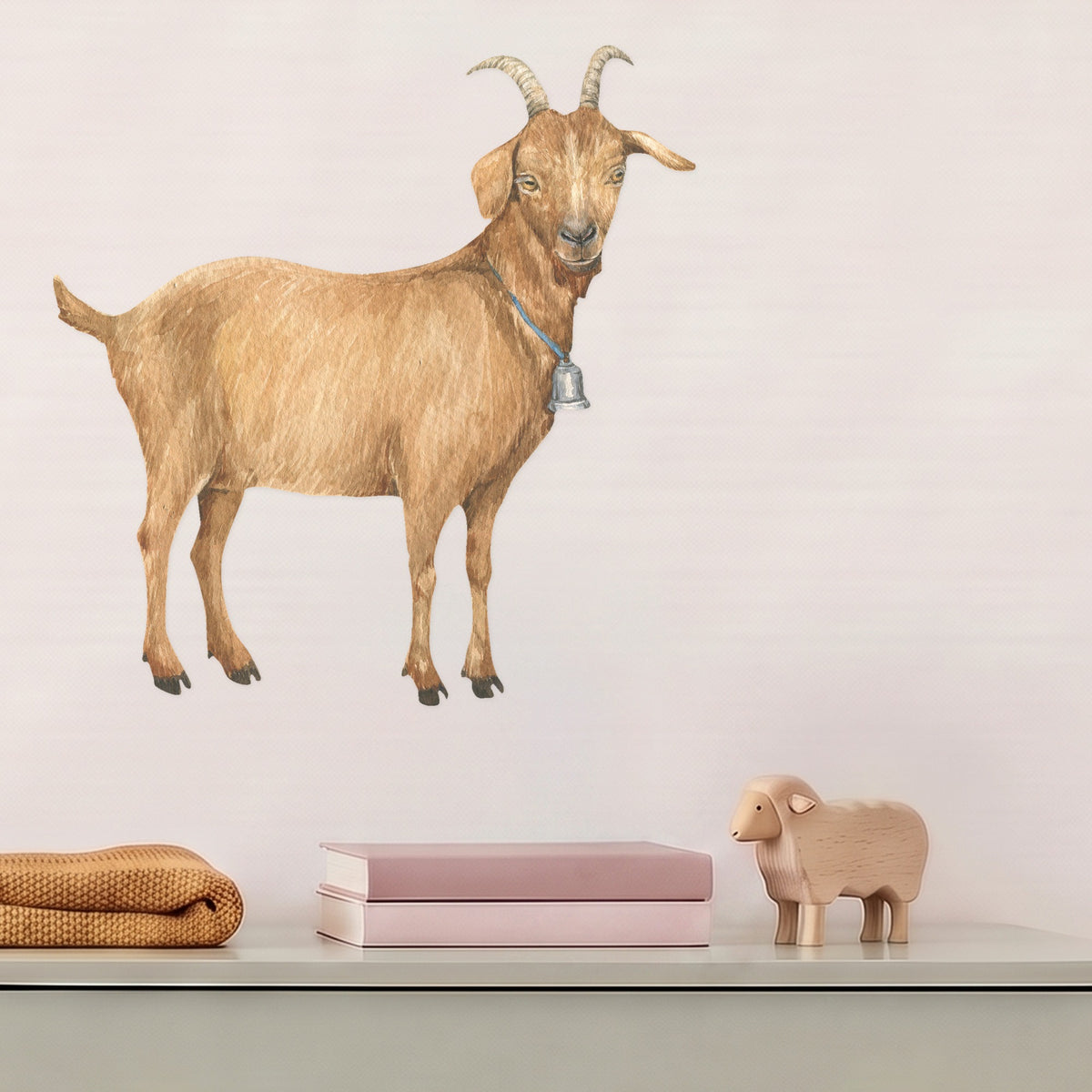 Large goat wall decal above a sage dresser in a nursery