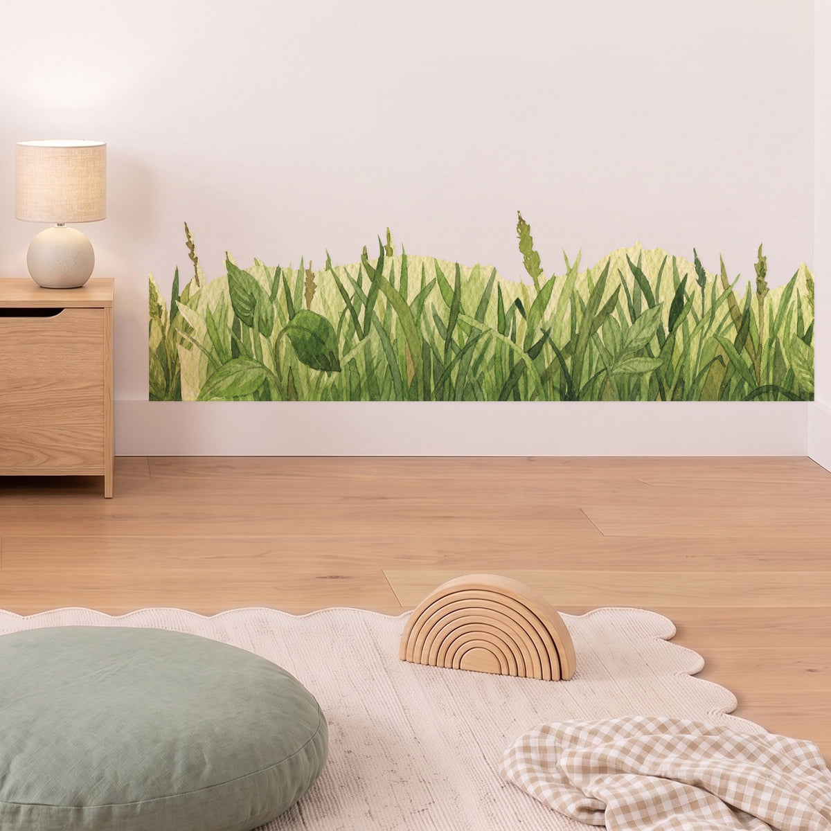 Green grass wall trim decal along the skirting in a styled nursery