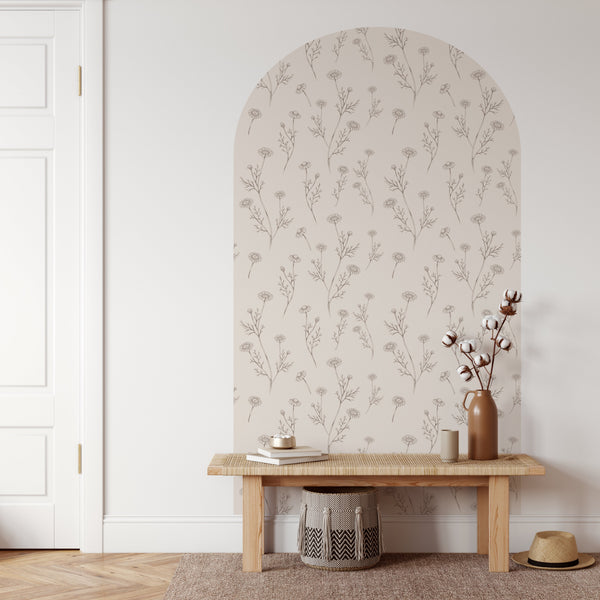 Niche with floral wallpaper, wooden bench, and decorative items in a room.