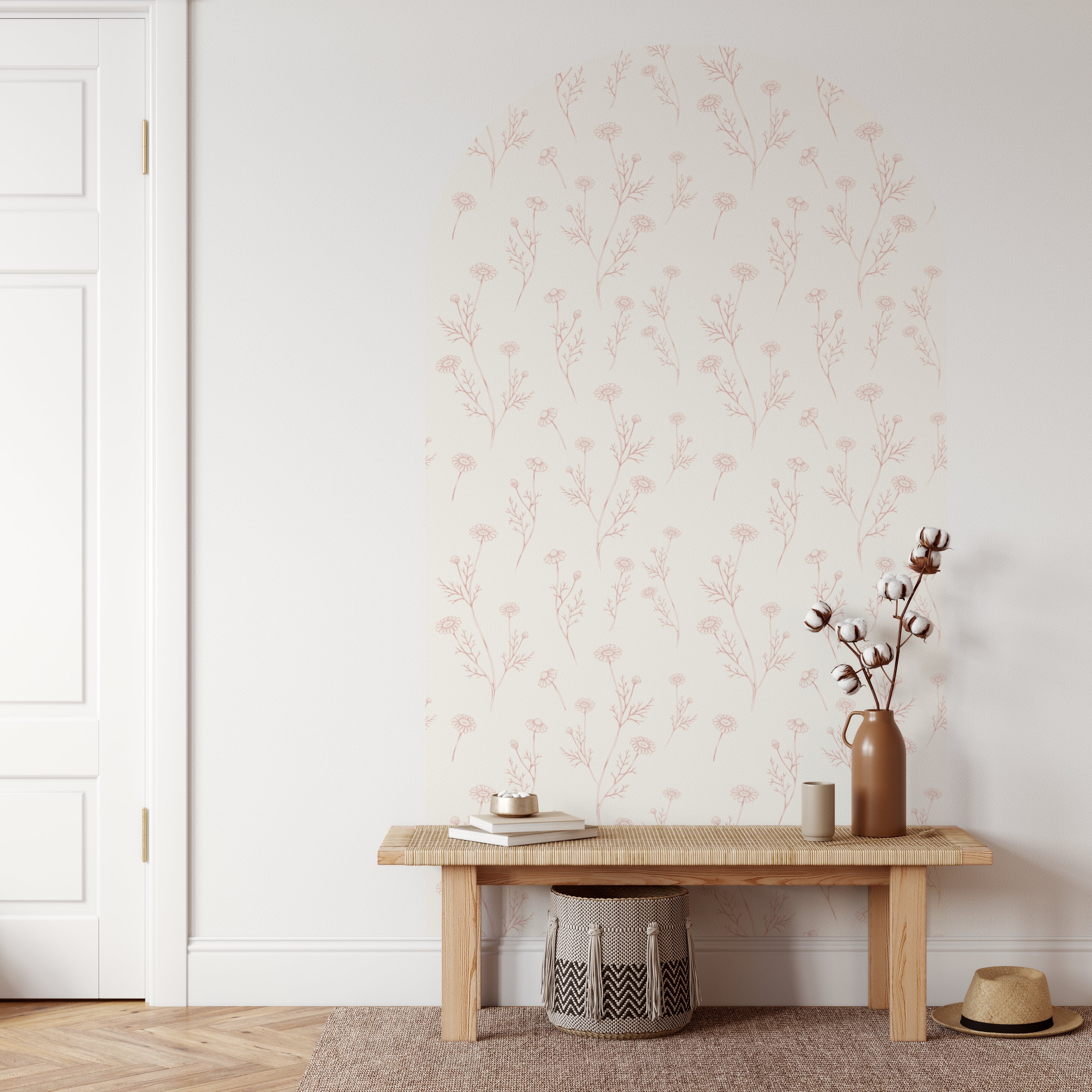 Minimalist interior with a wooden bench, vase, and books against a floral wallpaper wall.