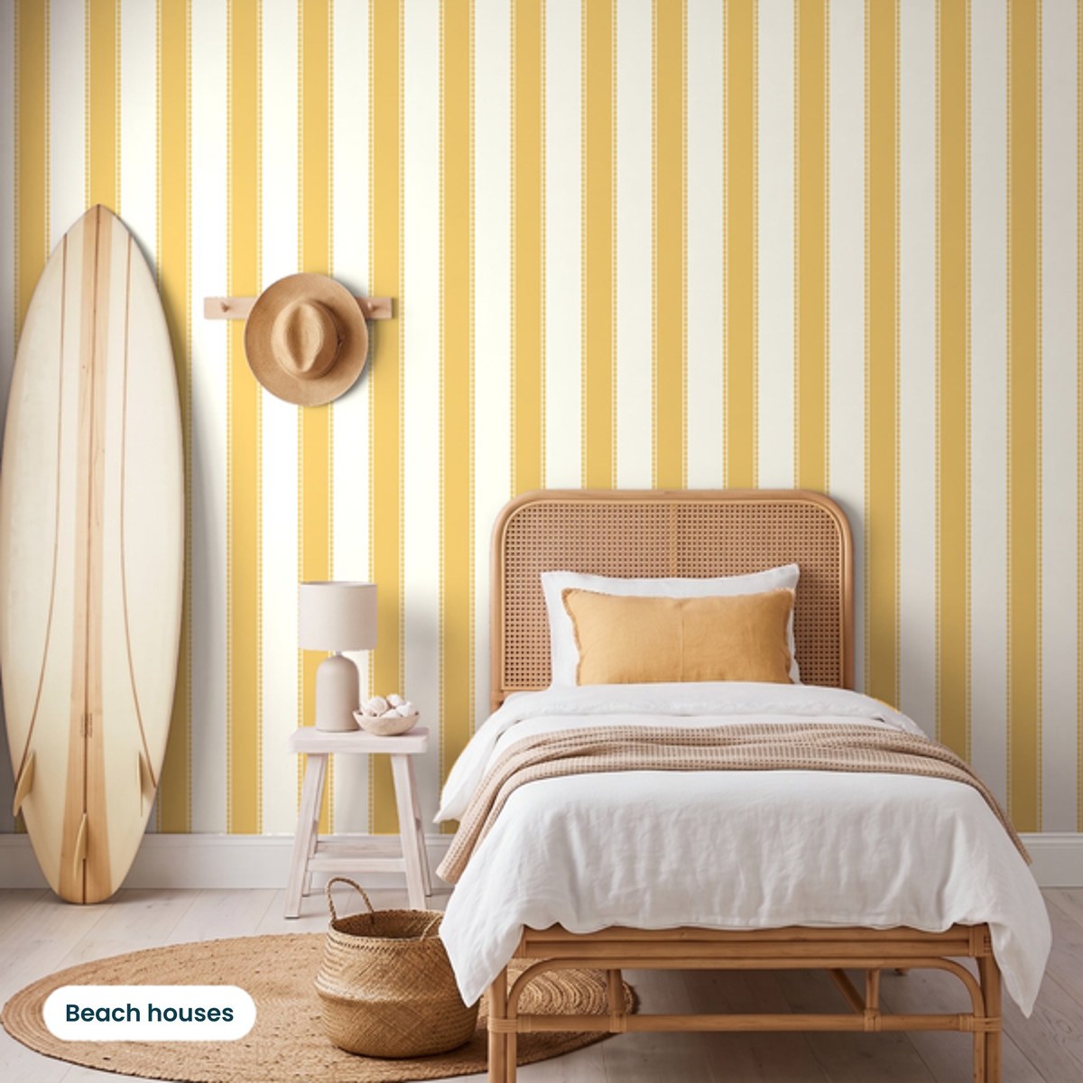 Henrietta Butterscotch Stripes wallpaper in a beach house bedroom with a rattan bed and timber surfboard