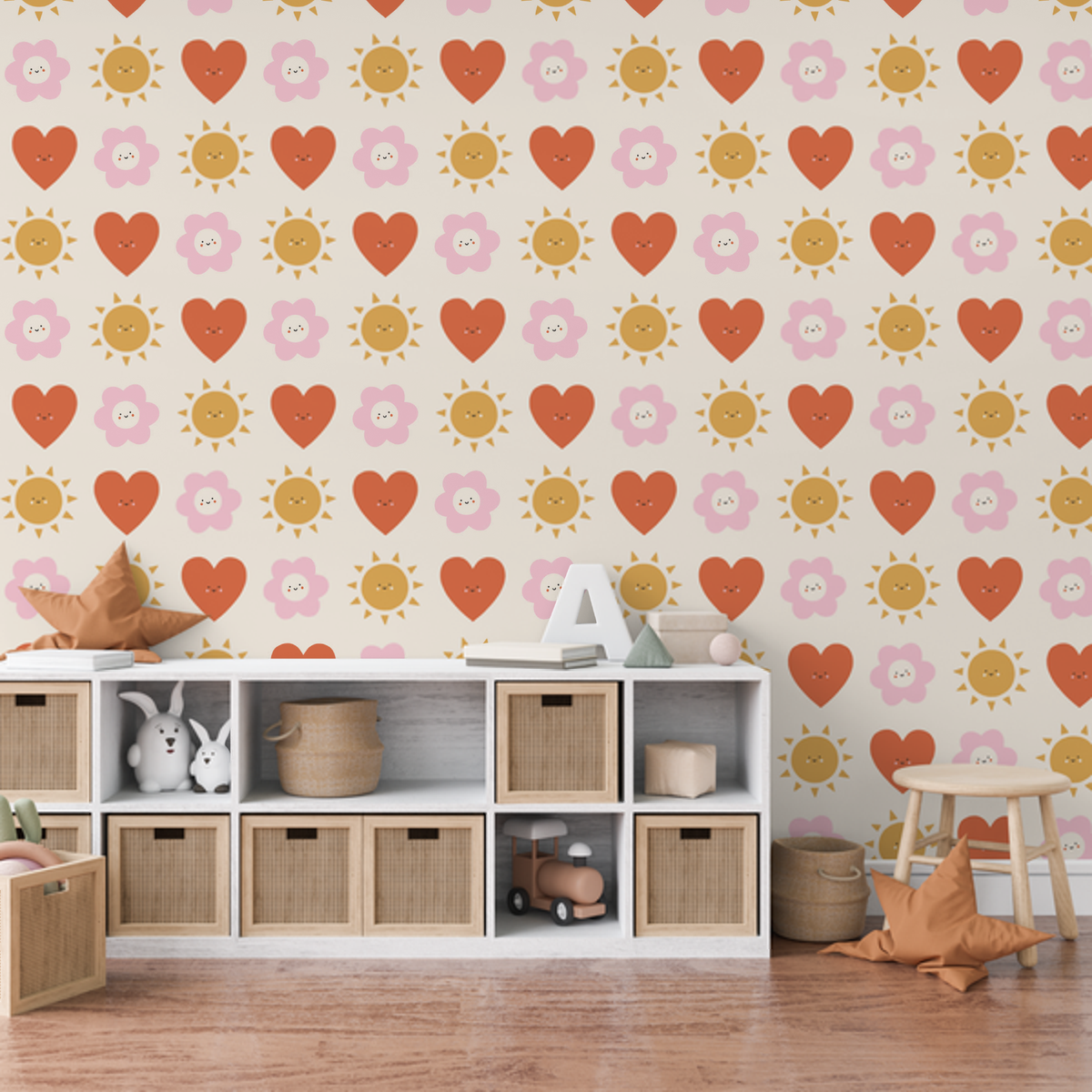 Hearts, suns and daisies kids wallpaper in a playroom above white storage cubes