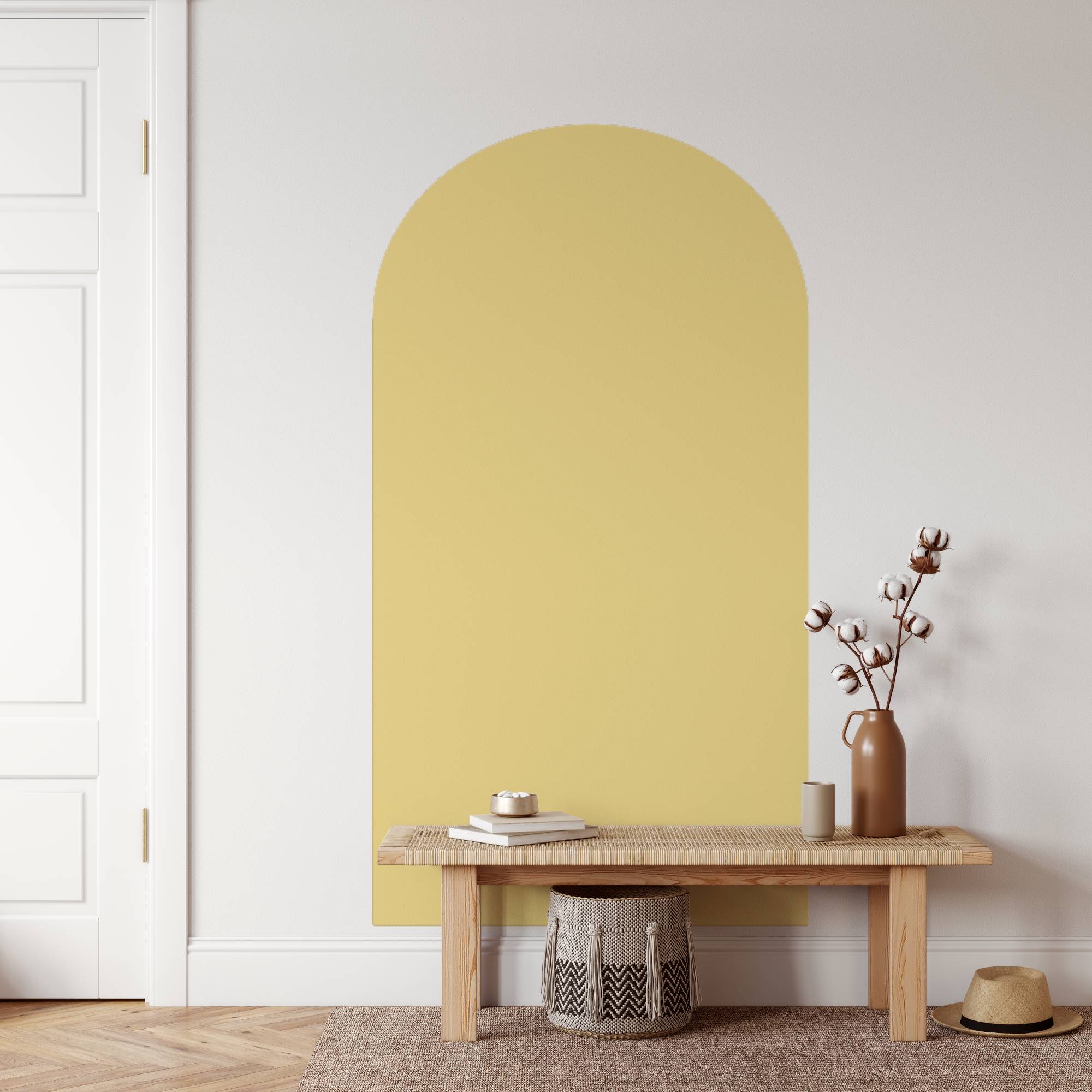 Yellow wall with a wooden bench and decorative items in a minimalistic room.