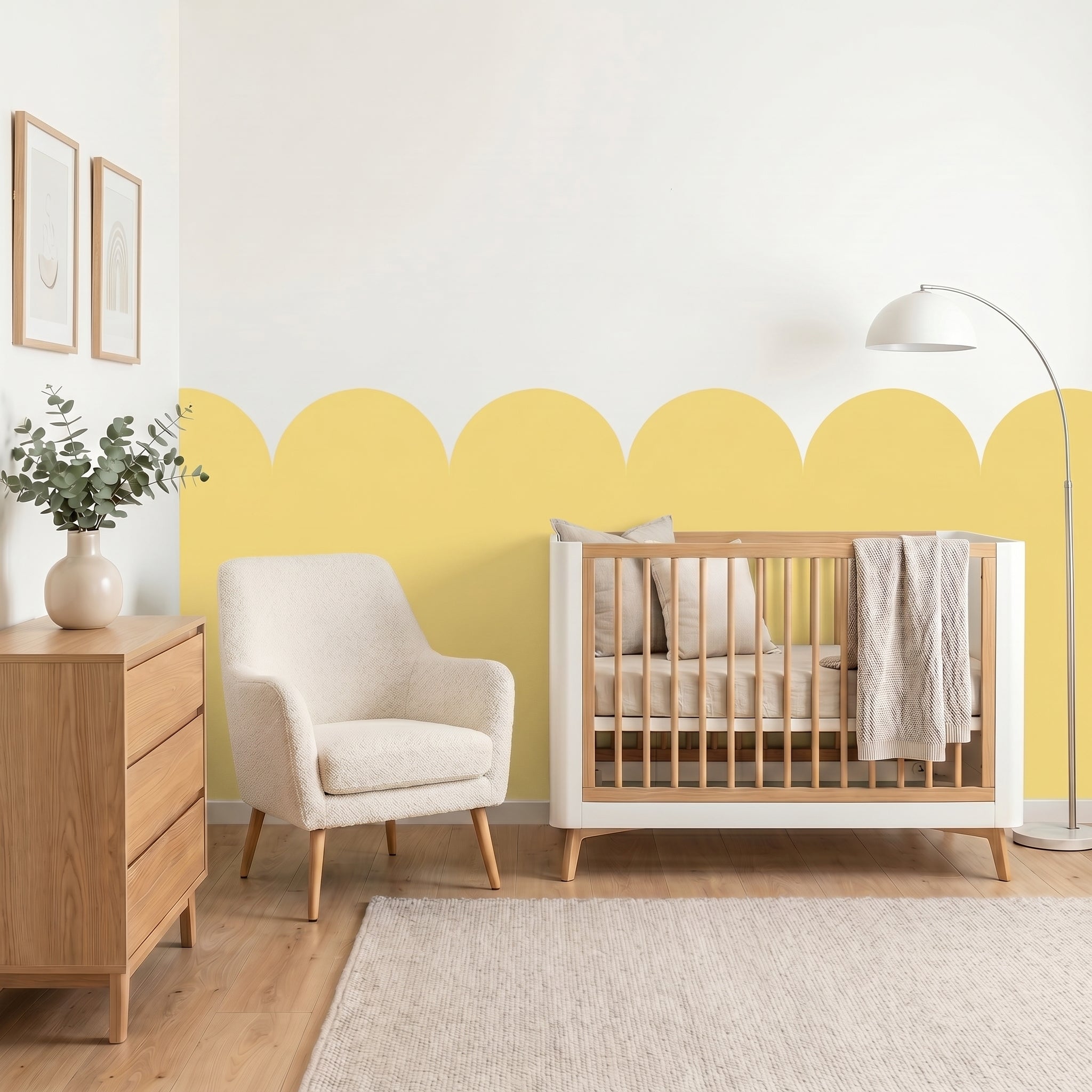 Nursery room with wooden crib, armchair, and dresser against a yellow accent wall.