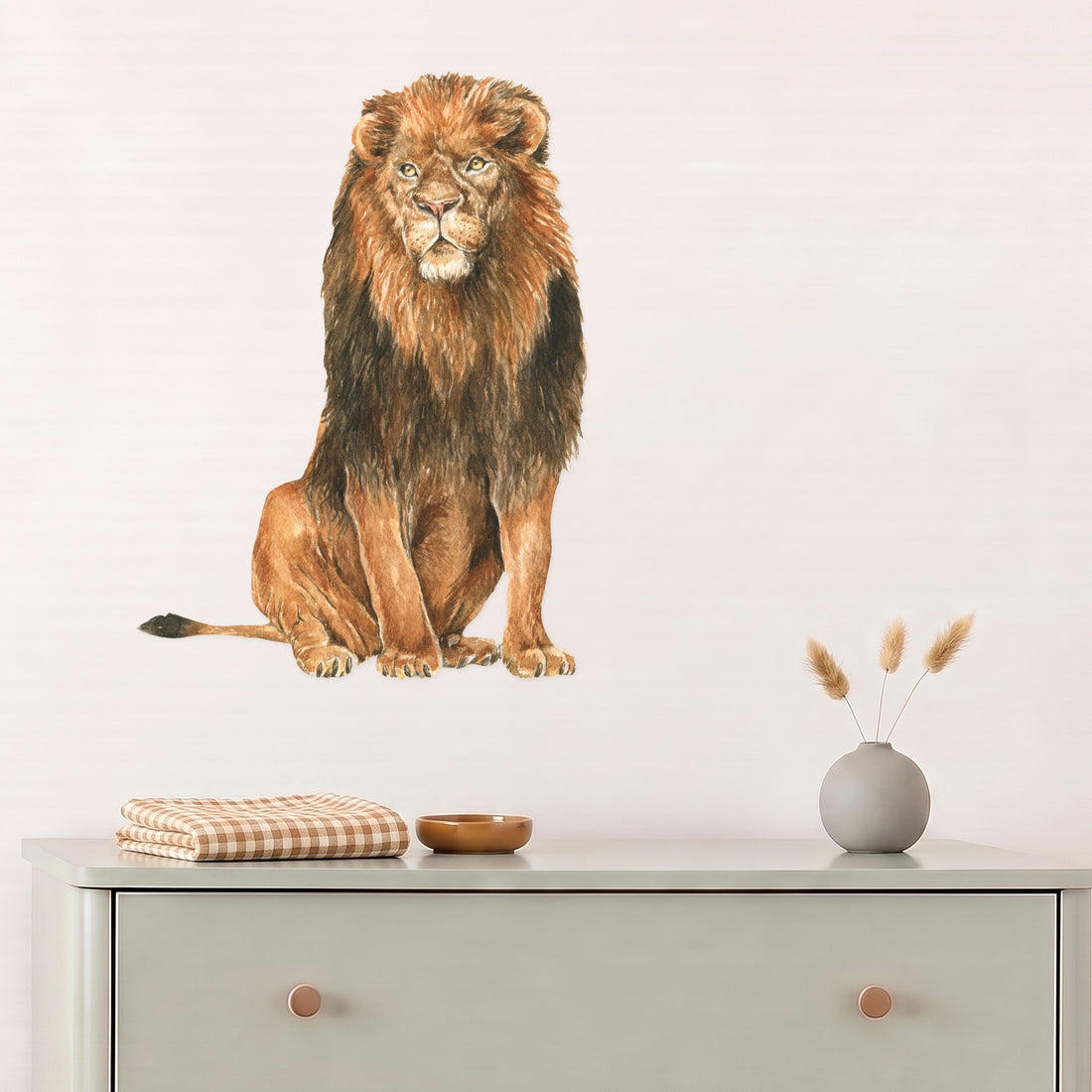 Large lion wall decal above a sage dresser in a nursery