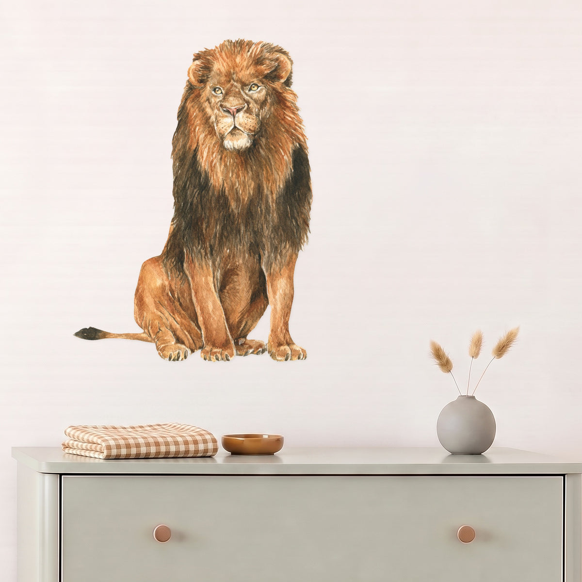 Large lion wall decal above a sage dresser in a nursery