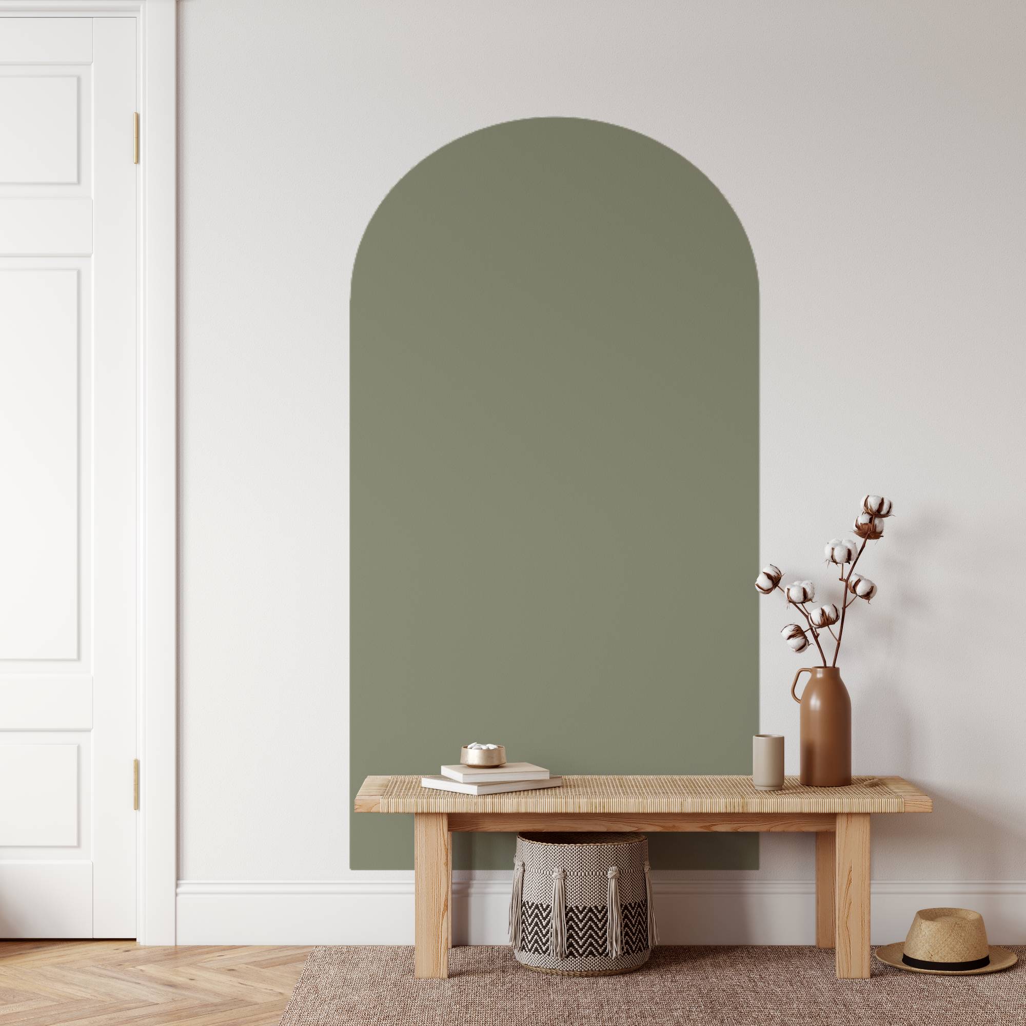 Green wall with a wooden bench and decorative items in a minimalistic room.