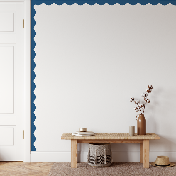 Wooden bench with decorative items against a white wall with blue accent stripe