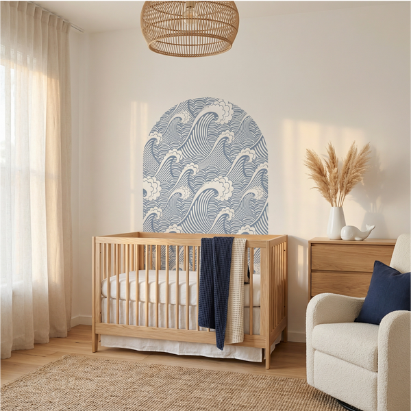 Nursery room with wooden crib, decorative wall art, and a cozy armchair.