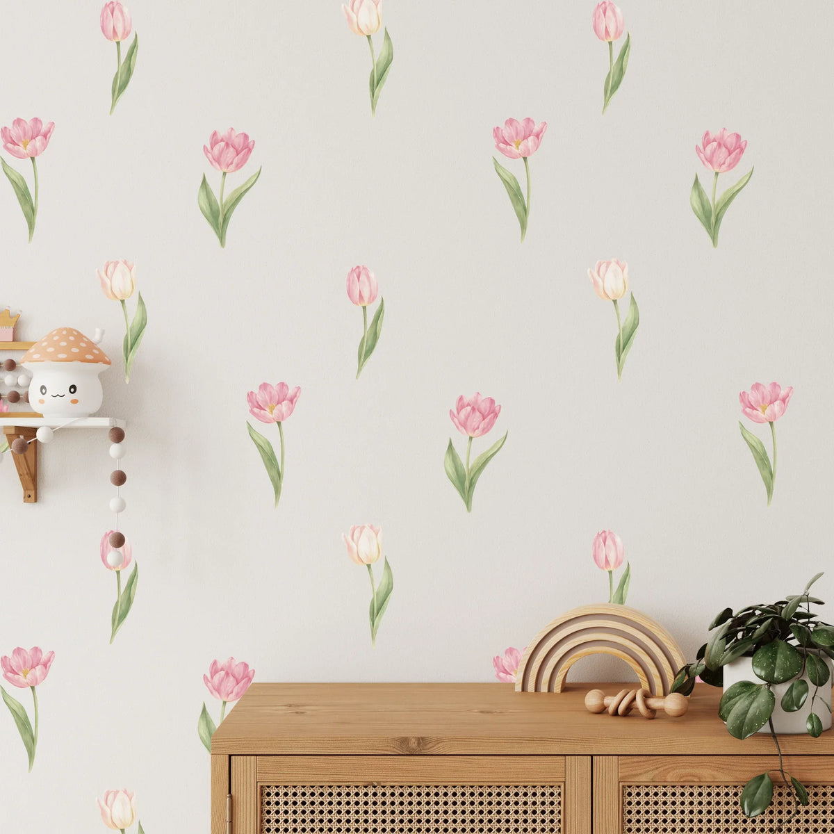 Pink tulip wall decals scattered above a cane sideboard