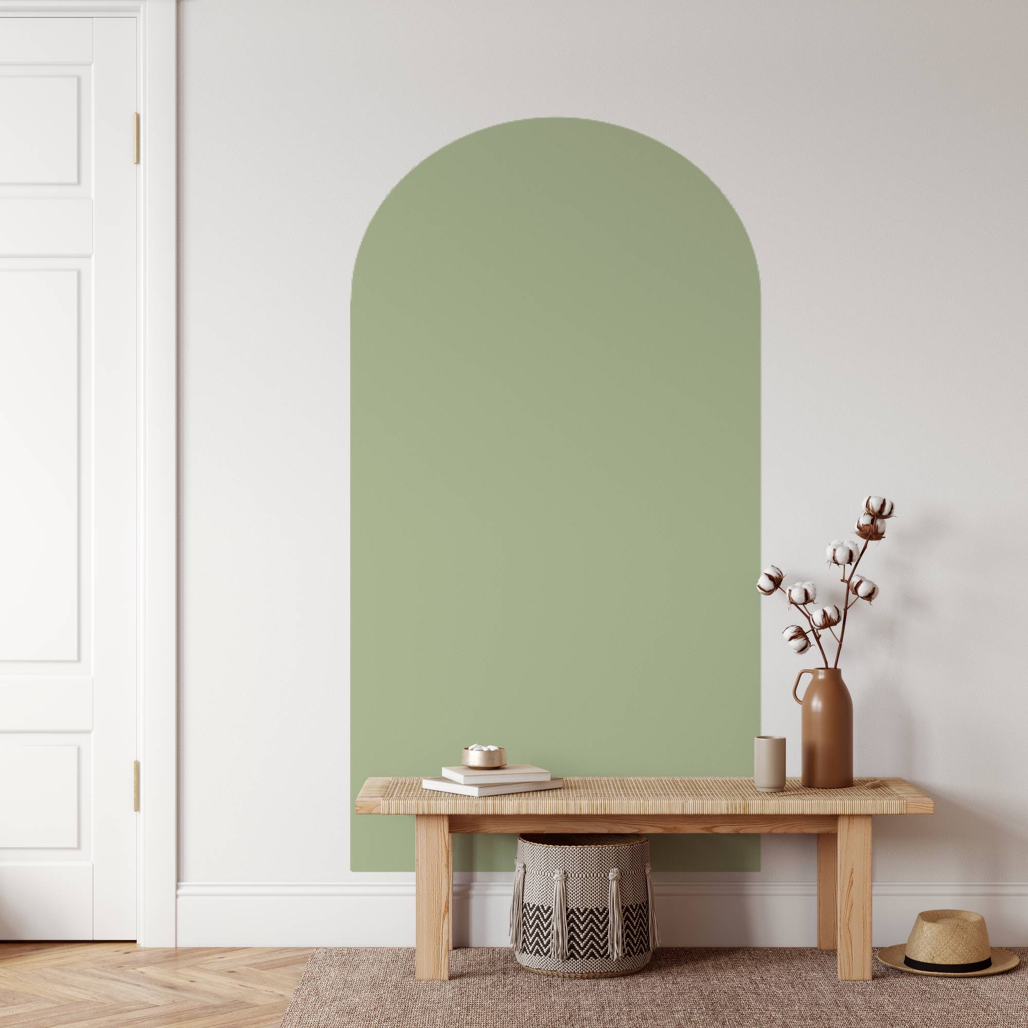 Green wall with a wooden bench and decorative items in a minimalistic room.