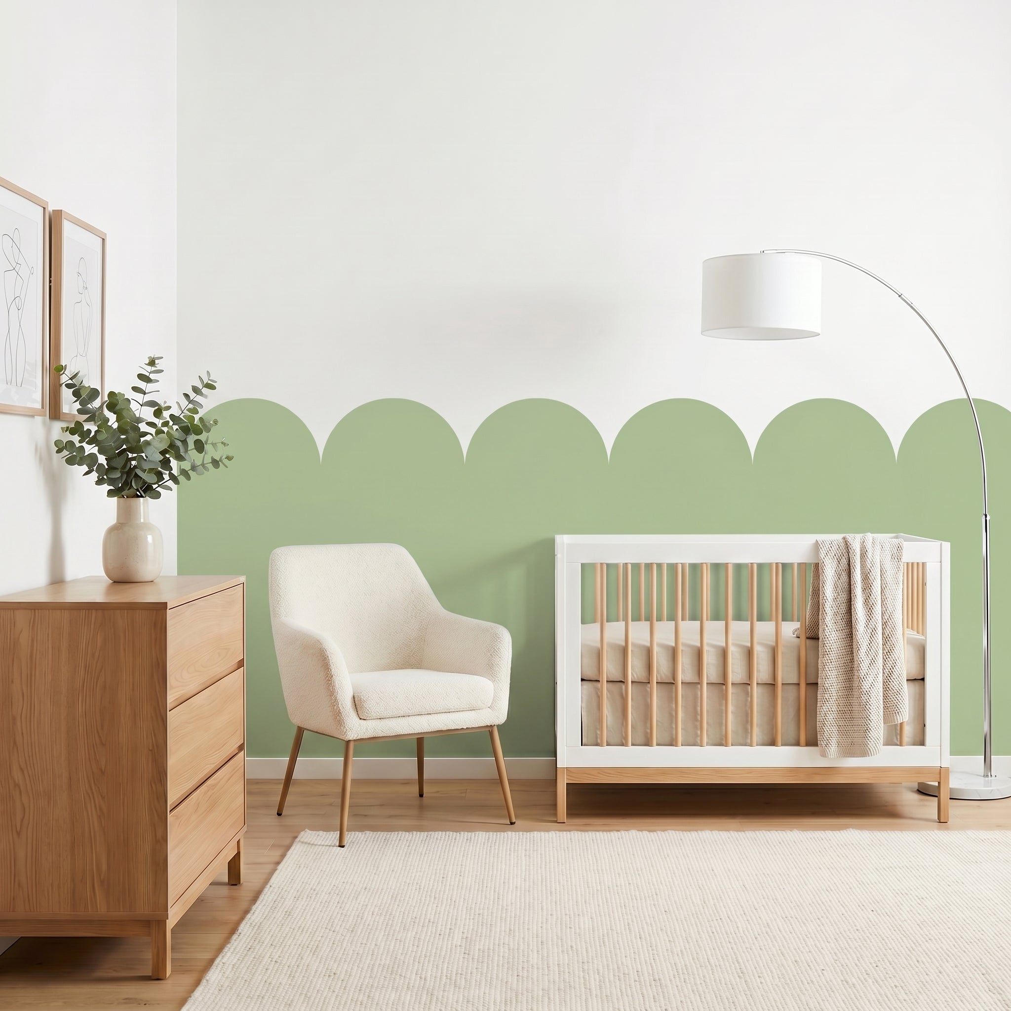 Nursery room with a crib, chair, and dresser against a green wall.