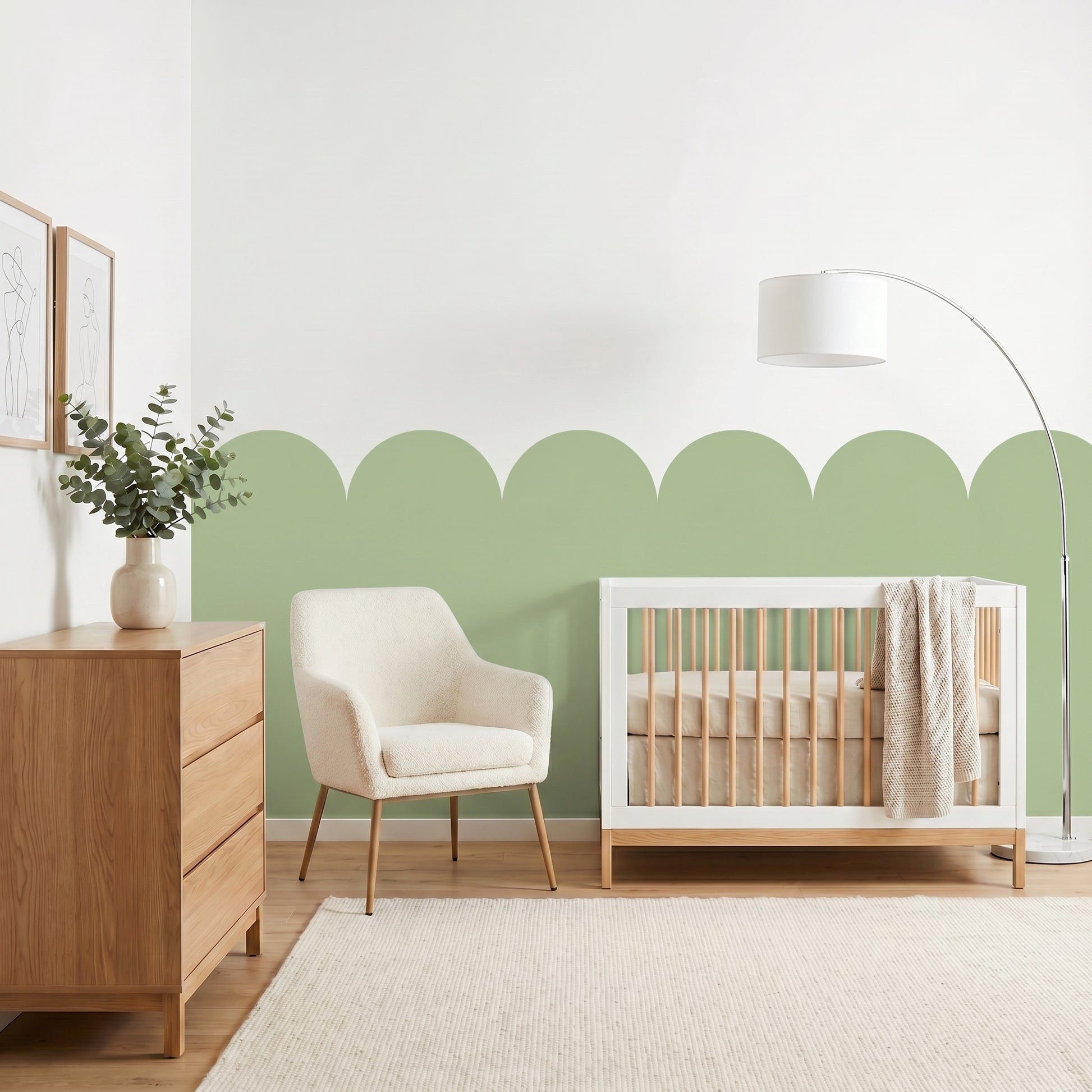 Nursery room with a crib, chair, and dresser against a green wall.
