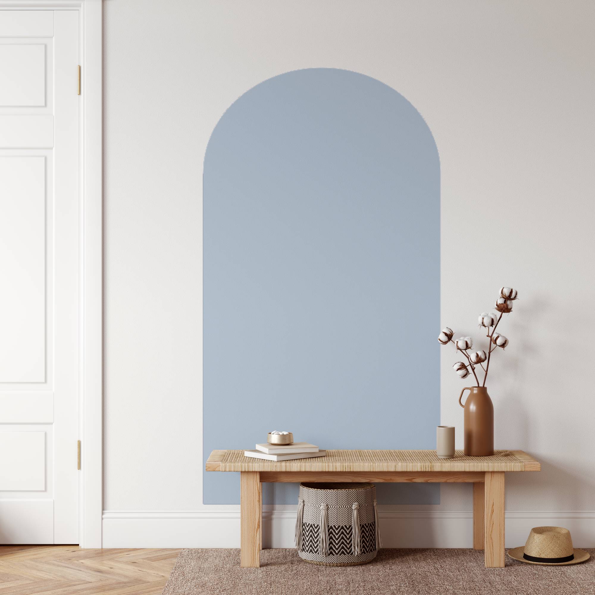 Arched blue wall panel in a room with a wooden bench and decorative items.