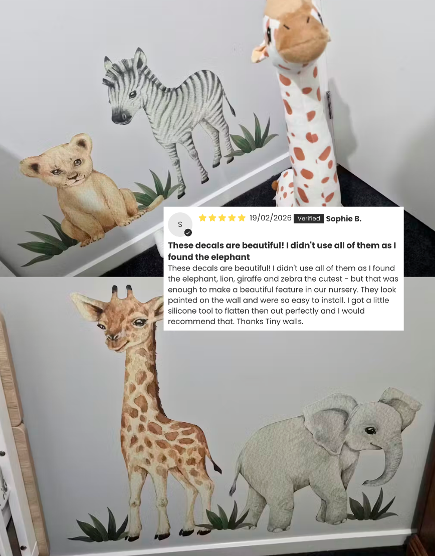 Children's room with animal wall decals and a stuffed giraffe toy.