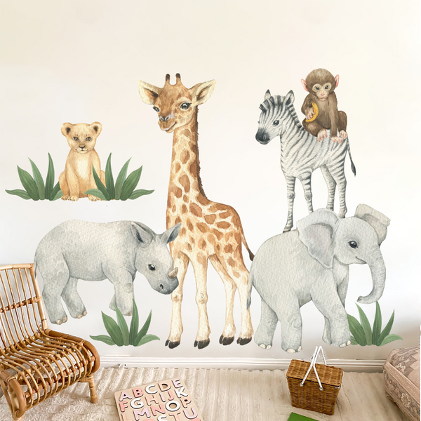 Wall decal of giraffe, zebra, elephant, rhino, and lion in a room with a chair and toys.