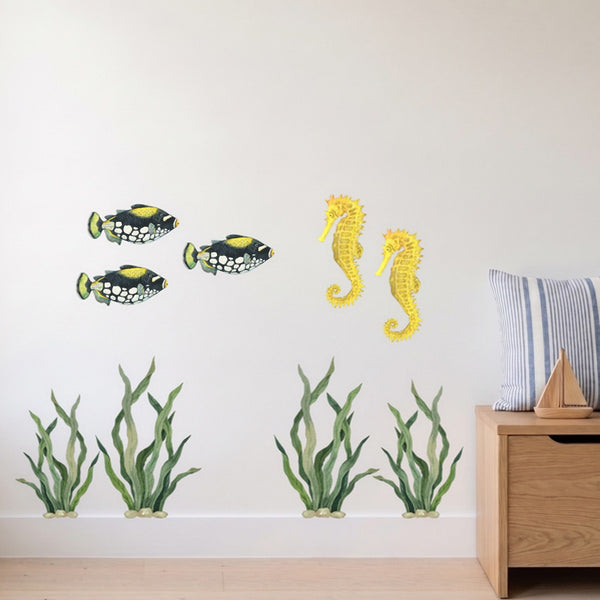 Seagrass, fish and seahorse wall decals: seagrass growing up from the skirting with a school of fish and two seahorses above, beside an oak toy box