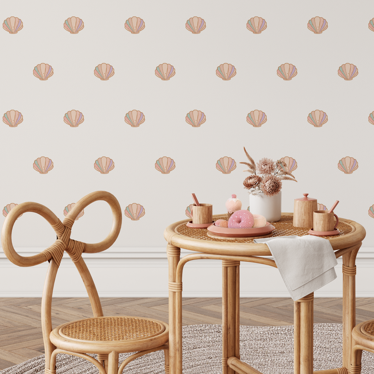 Sea shell wall decals scattered above a kids table and chairs