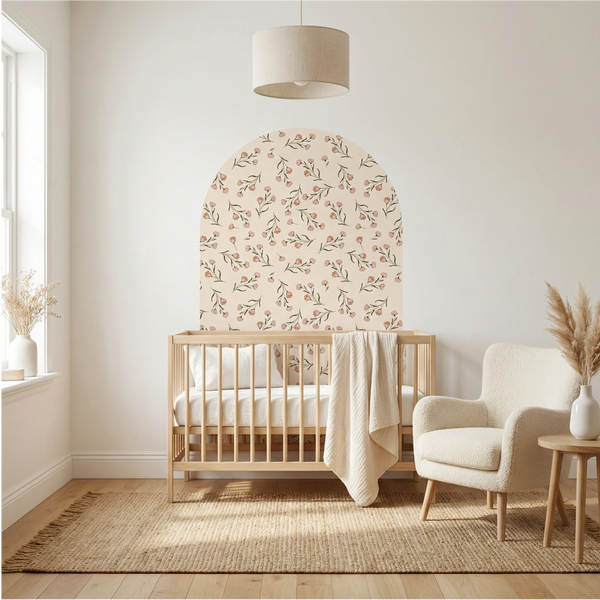 Nursery room with wooden crib, floral headboard, and armchair.