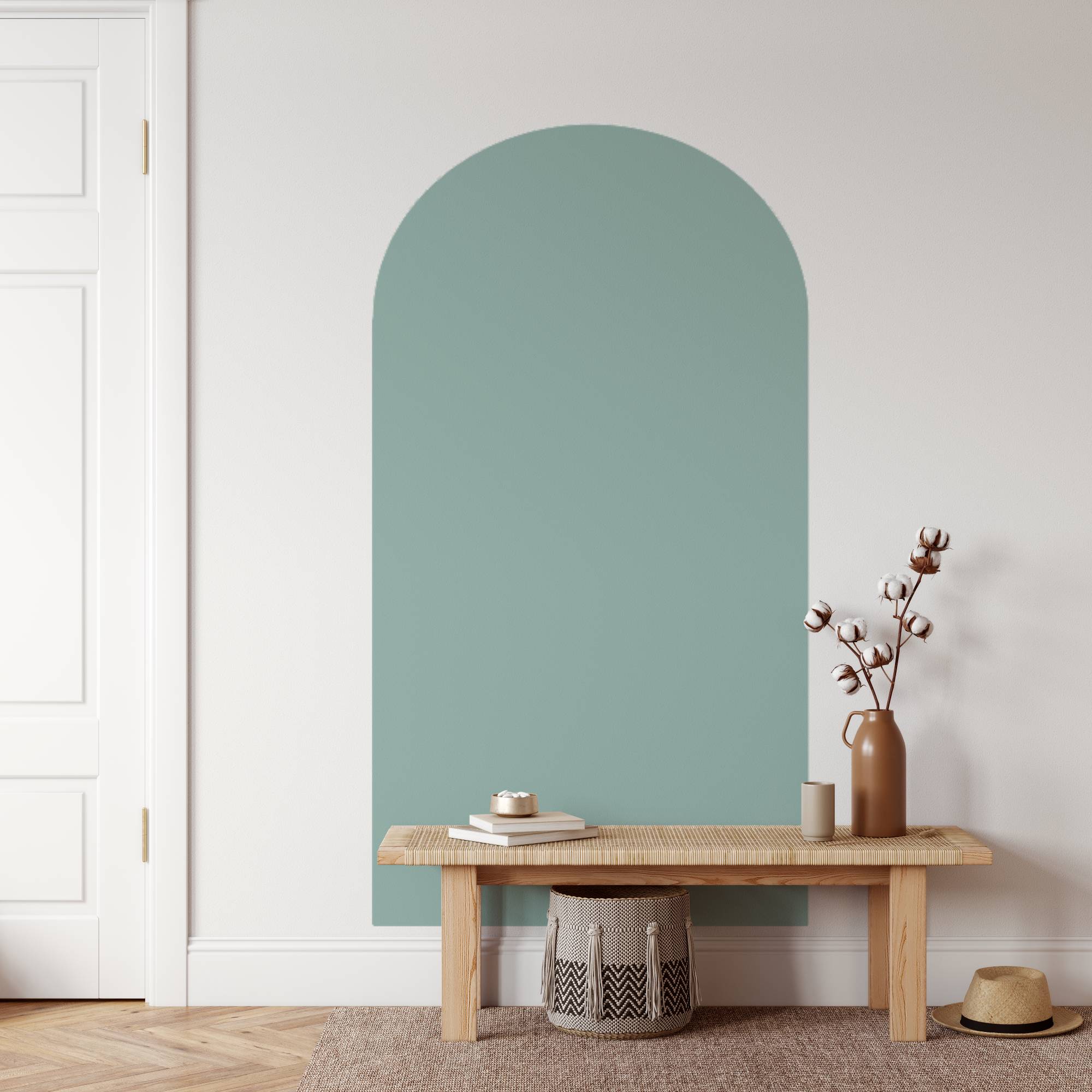 Arched green wall panel in a room with a wooden bench and decorative items.