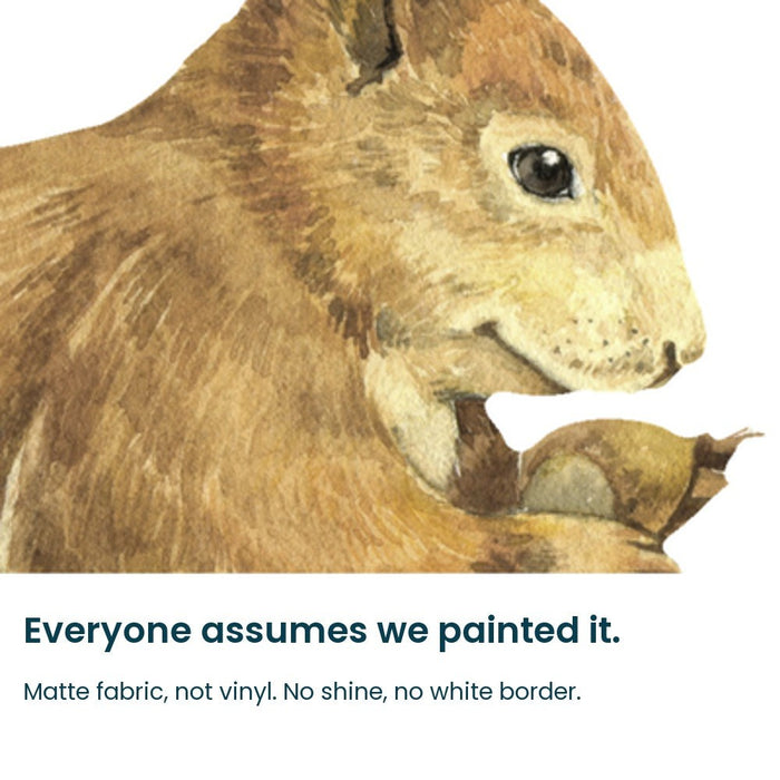 Close-up of the hand-painted squirrel face and hazelnut on matte fabric